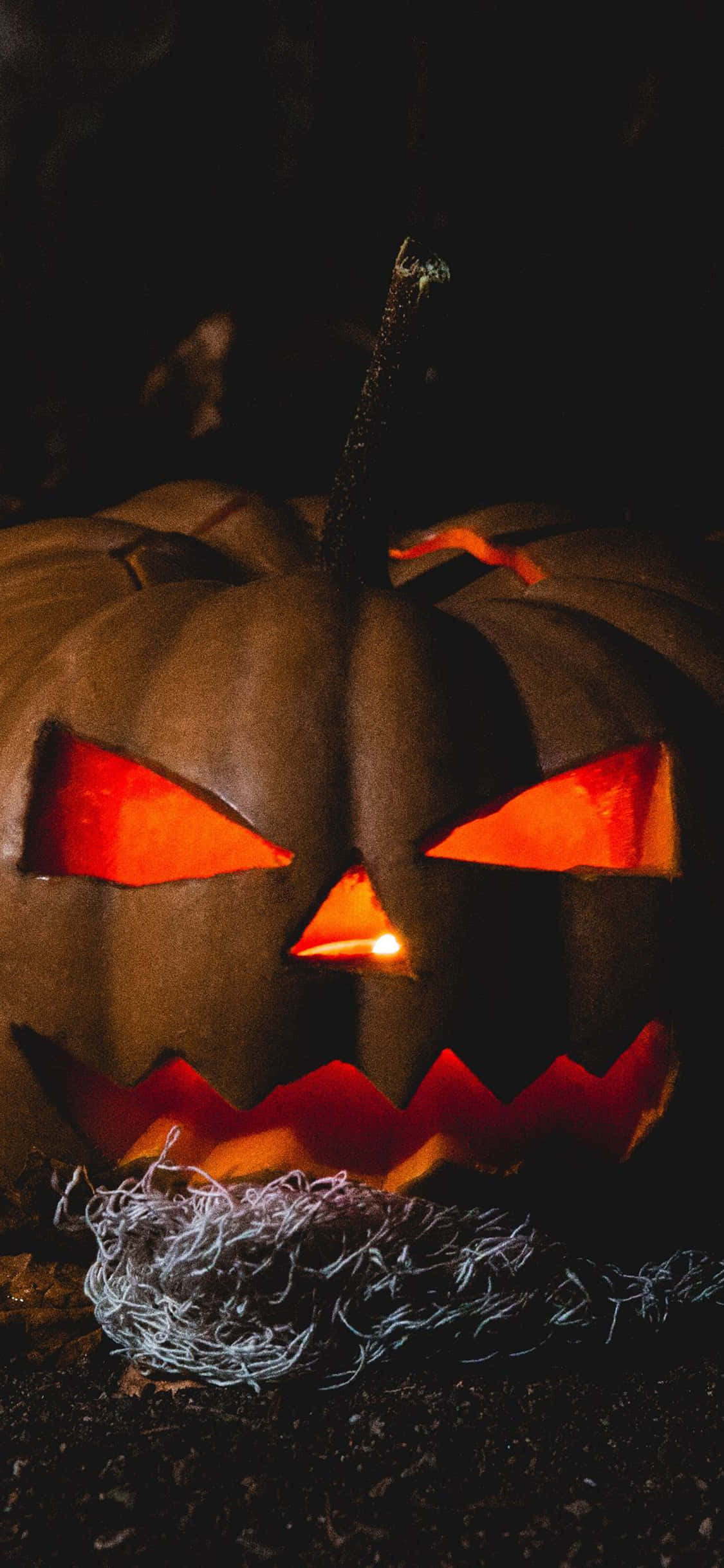 พื้นหลังฮาโลวีน iPhone ของ Jack O'Lantern น่ากลัว วอลเปเปอร์