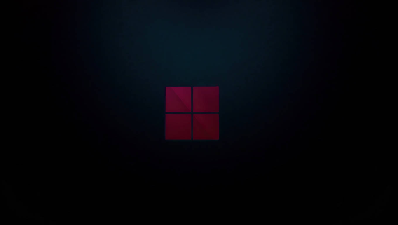 โลโก้ Windows 11 บนแล็ปท็อปสีเข้ม วอลเปเปอร์