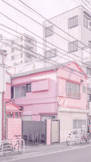 บ้านสุนทรียะสีชมพูข้างอาคารสีขาว — พาสเทลสีชมพู วอลเปเปอร์